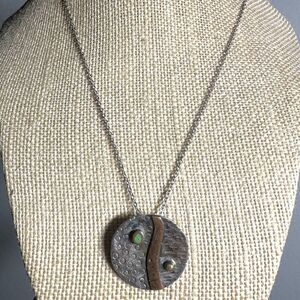 Silver tone and copper round pendant necklace